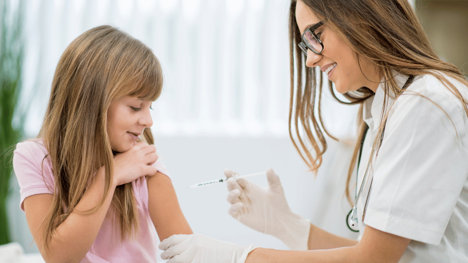 Young girl receiving a flu shot from a healthcare professional at CityMD